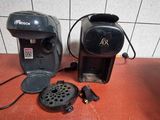 two coffee machines sitting on a counter next to each other