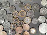 a lot of coins that are on the table