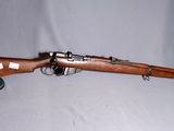 an old wooden rifle with a green hat on a white background
