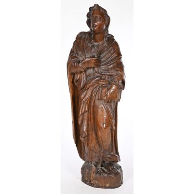 a carved wooden statue of a woman holding a child