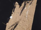 an image of a piece of brown paper with red and blue paint on it