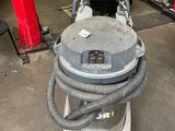 a machine that is sitting on a stand in a garage