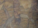 a close up of a wooden table with a painting on it