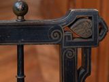 a close up of a chair with a wooden floor in the background
