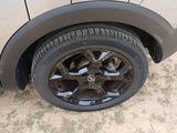 a close up of a car ' s tire on a dirt road
