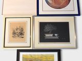 four framed pictures on the wall of a room