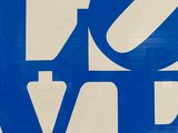 a blue and white sign with the word love written on it