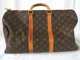 louis vuittou bag on a bed with a white background