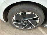 a close up of a tire on a white car