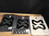 three t - shirts with black and white logos are sitting on a table