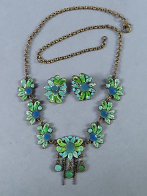 gros plan d'un collier et de boucles d'oreilles sur une surface blanche