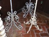two white wrought iron candlesticks on the floor