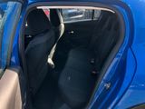 the back seat of a blue car with the door open
