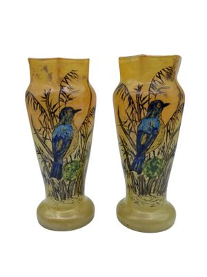 deux vases avec des oiseaux peints assis sur une table