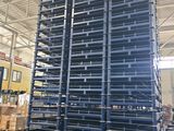 a large stack of tires sitting on top of a pallet in a warehouse