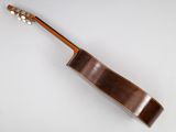 a close up of a guitar on a white surface