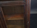 a cabinet that has a glass door on top of it