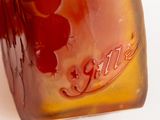 a glass vase that has a brown and red design on it