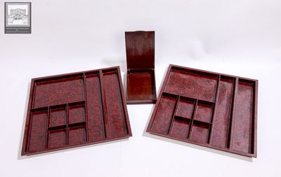 trois plateaux en bois à compartiments posés sur une surface blanche