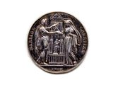 une image représentant une pièce d'argent sur laquelle figurent une femme et un homme