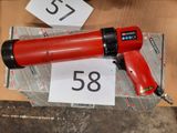 an image of a red air gun sitting on top of a box