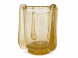 a yellow glass vase with a spoon inside of it