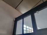 a window in the corner of a building with a skylight above it