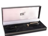 a black and gold ballpoint pen in a black box