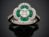 an emerald and diamond flower ring