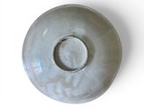 a white bowl with a hole in it on a white surface
