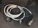 a cable connected to a power cord on the ground