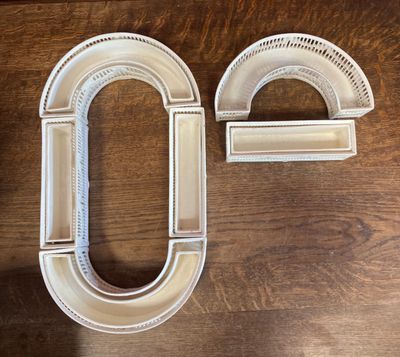 a close up of a pair of white letters on a wooden table