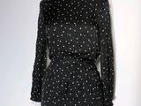 the dress is black and white with white dots on it