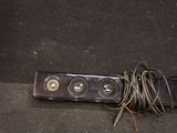 two speakers and a cord on the ground next to each other