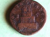 a close up of a coin on a table with a green background