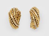 a pair of gold and diamond earrings