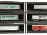 six train cars that are in a display case