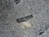 a black and white photo of a sign on the ground
