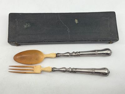 two wooden spoons and a wooden fork in a black case