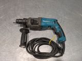a cord connected to a drill on a table