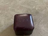 purple glass box with the word epi on it sitting on a table