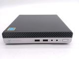 a close up of a small black computer on a white surface