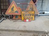 two street signs that are on the ground next to each other
