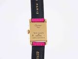 black and pink leather belt with a gold buckle on a white background