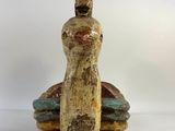 ceramic figurine of a woman sitting on a boat with a hat on her head