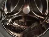 a close up view of a washing machine with the door open