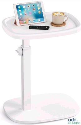 the tablet is sitting on a tray with a cup of coffee on it