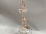 an orange and white glass vase with a spiral design on the base
