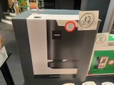 a box with a coffee maker on it in a store