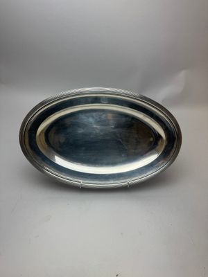 un plateau d'argent sur une table blanche avec un fond blanc